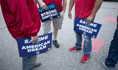 Stellantis workers attend a rally with United Auto Workers president Shawn Fain to mark the beginning of the UAW's contract talks with Stellantis in July. The union announced on August 31 that it filed unfair labor practice charges against Stellantis and GM.