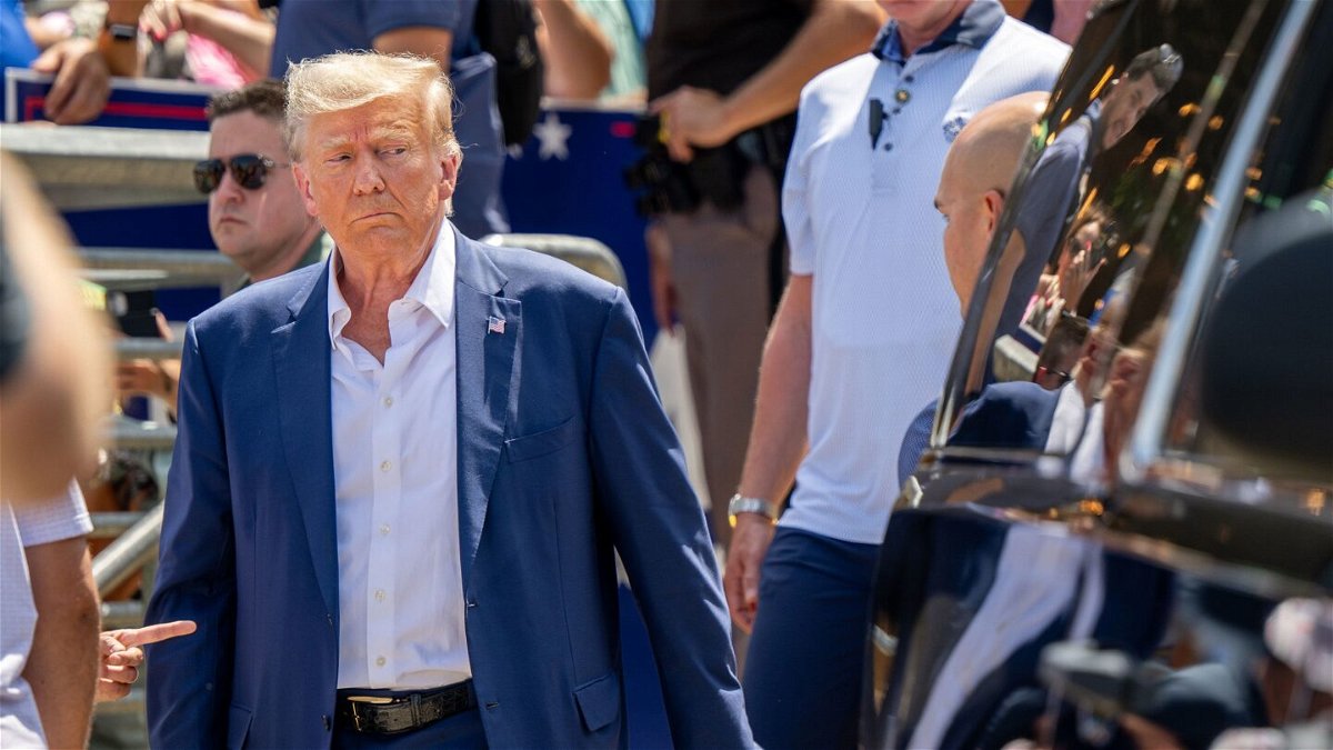 <i>Brandon Bell/Getty Images</i><br/>Republican presidential candidate and former President Donald Trump is directed to his vehicle after speaking at the Steer N' Stein bar at the Iowa State Fair on August 12 in Des Moines