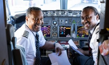 Here's Captain Ruben Flowers and First Officer Ruben Flowers recreating the 1990s photo in 2023.