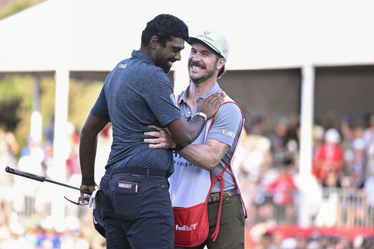 <i>Orlando Ramirez/Getty Images</i><br/>Theegala is congratulated by caddie Carl Smith.