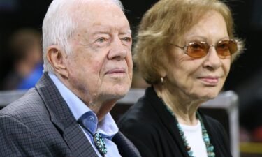 Former President Jimmy Carter and first lady Rosalynn Carter attend an NFL game between the Atlanta Falcons and Cincinnati Bengals on September 30