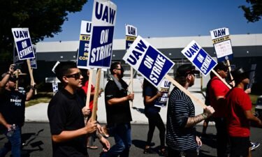 Labor supporters and members of the United Auto Workers union (UAW) Local 230 march along a picket line during a strike outside of the Stellantis Chrysler Los Angeles Parts Distribution Center in Ontario