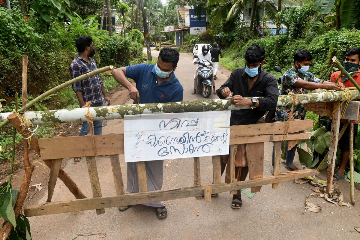 <i>Stringer/Reuters</i><br/>A medical team from Kozhikode Medical College carry areca nut and guava fruit samples to conduct tests for Nipah virus in the Kozhikode district of Kerala