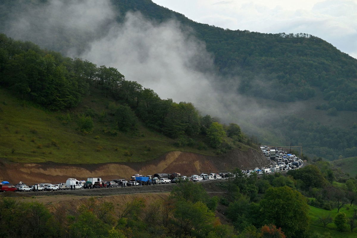 <i>David Ghahramanyan/Reuters</i><br/>Vehicles carrying refugees from Nagorno-Karabakh head toward the Armenian border on September 25