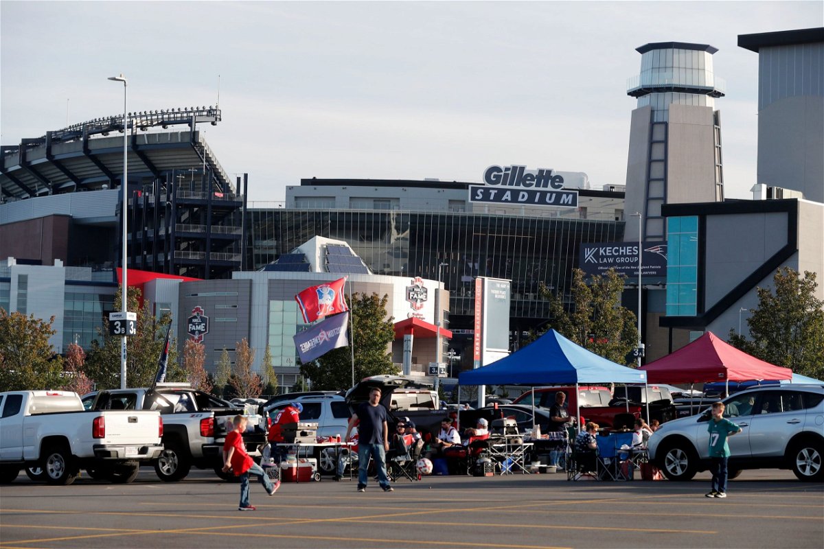<i>Michael Dwyer/AP</i><br/>People tailgate outside Gillette Stadium before an NFL game between the New England Patriots and the Miami Dolphins on September 17.