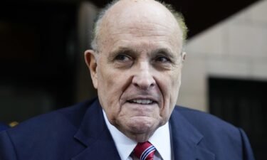 Former Mayor of New York Rudy Giuliani speaks to reporters as he leaves his apartment building in New York