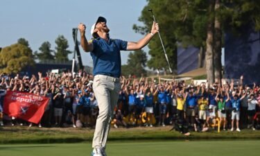 Europe's English golfer Tommy Fleetwood celebrates the winning putt on the 17th green during his singles match on Sunday.