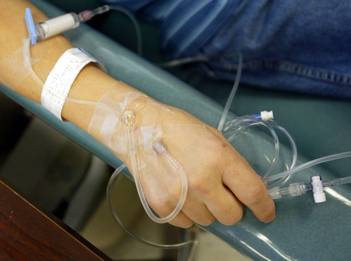 <i>Chris Hondros/Getty Images/File</i><br/>A cancer patient holds the IV tubes during chemotherapy.