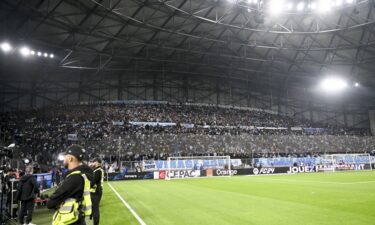 Fans wait to see if the match between Marseille and Lyon will go ahead.