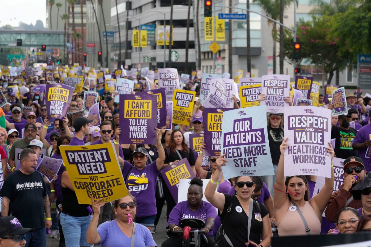<i>Damian Dovarganes/AP</i><br/>Frontline healthcare workers hold a demonstration on Labor Day outside Kaiser Permanente Los Angeles Medical Center in Hollywood in Los Angeles