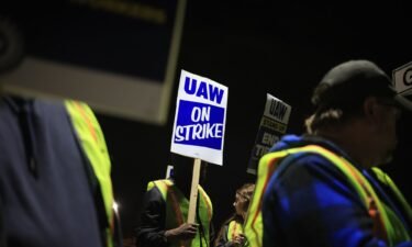 Factory workers and UAW union members form a picket line outside the Ford Motor Co. Kentucky Truck Plant in the early morning hours on October 12