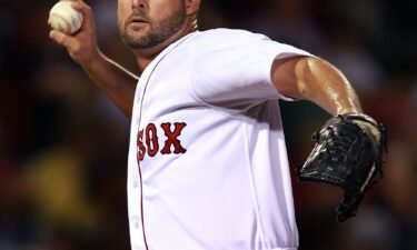 Red Sox pitcher Tim Wakefield waves to the crowd after winning his 200th (and final) career win in September 2011.