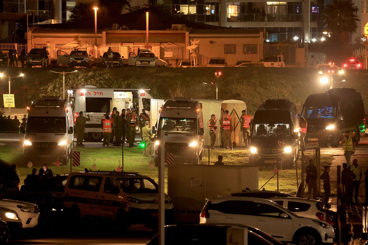 <i>Fadel Senna/AFP/Getty Images</i><br/>Israeli security forces stand next to ambulances waiting outside the helipad of Tel Aviv's Schneider medical center on November 24