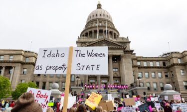 An attendee at Planned Parenthood's Bans Off Our Bodies rally for abortion rights holds a sign reading "Idaho the women as property state" outside of the Idaho Statehouse in downtown Boise