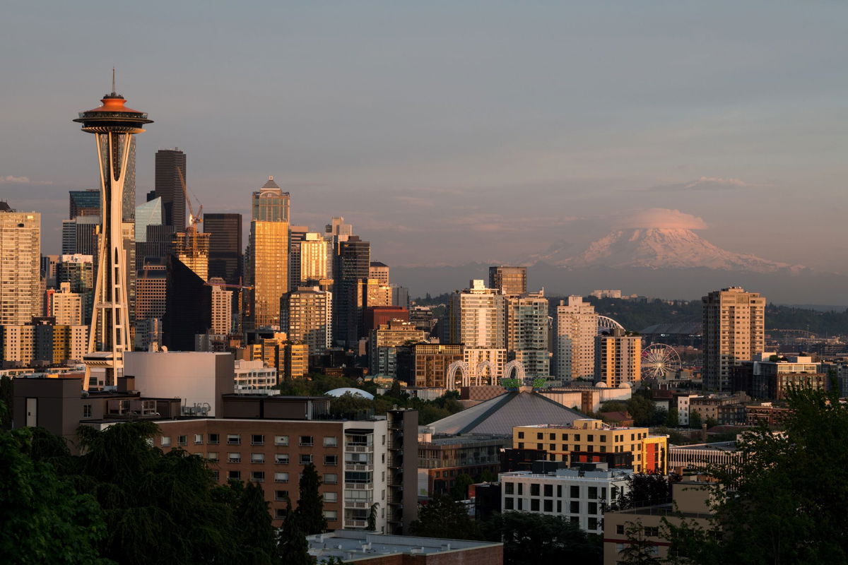 <i>400tmax/Getty Images</i><br/>The Seattle skyline at sunset with Mount Rainier in the background. Amtrak runs multiple trains between Seattle and Portland.