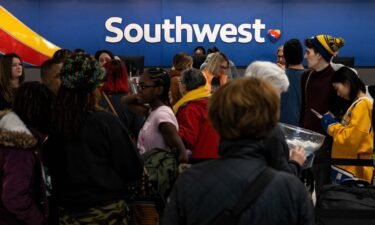 Travelers wait in line at the Southwest Airlines ticketing counter at Nashville International Airport after the airline canceled thousands of flights last December.