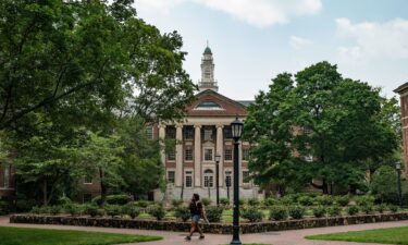 People walk on the campus of the University of North Carolina Chapel Hill on June 29