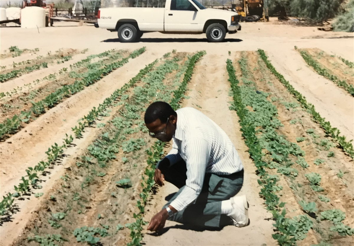 Sam Cobb inspecting a farmer's field during his 30 year career with the U.S. Department of Agriculture. 