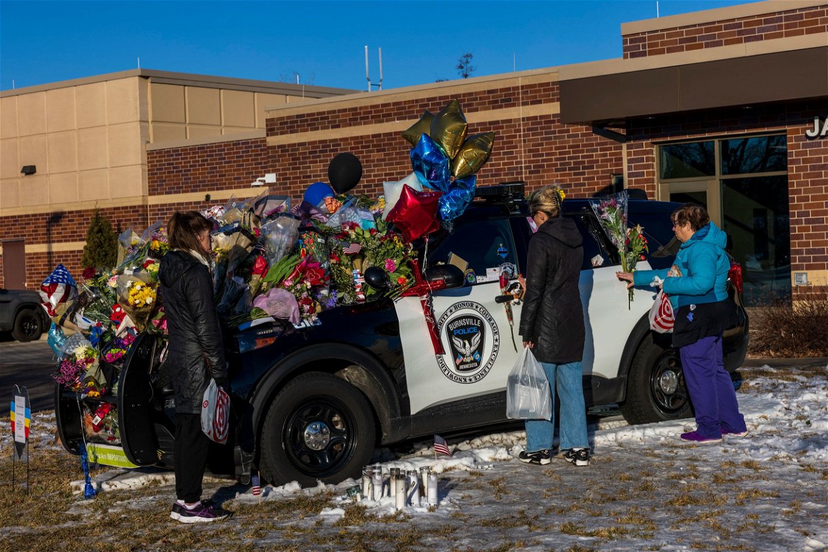 <i>Kerem Yücel/Minnesota Public Radio/AP</i><br/>People gather at one of three memorials outside the Burnsville Police Department and City Hall building in Burnsville