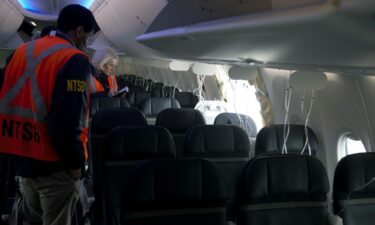 Members of the NTSB examine the hole in the fuselage plug area of Alaska Airlines Flight 1282.