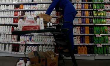 An employee of Unilever Indonesia arranges a shelf in Jakarta