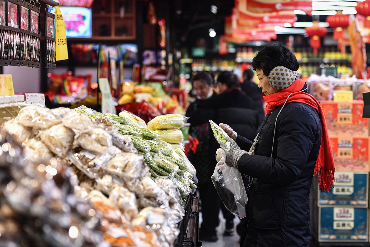 <i>STR/AFP/Getty Images</i><br/>Customers shop for vegetables and fruit at a supermarket in Fuyang