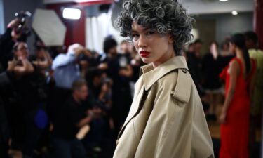 Salt and pepper permed wigs were paired with a striking red lip.