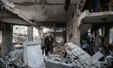 People inspect damage to their homes following Israeli air strikes on February 24