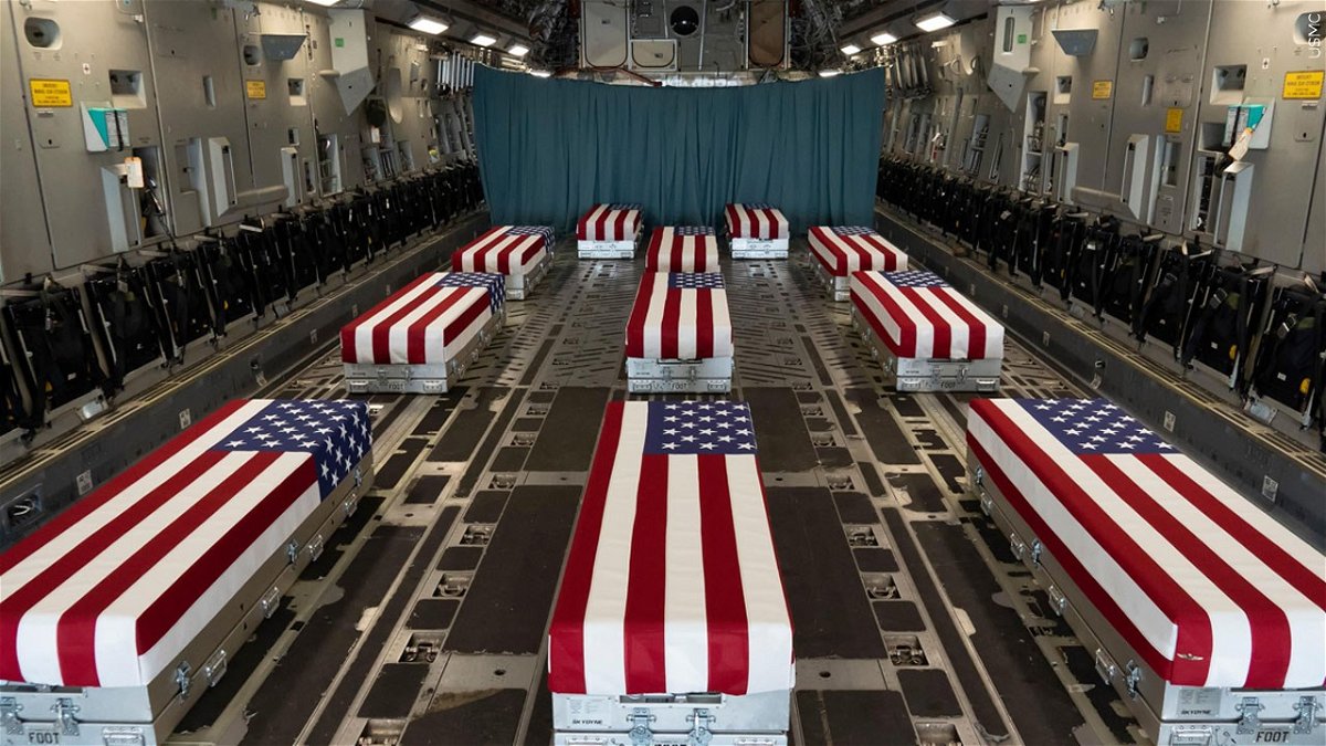 PHOTO: Flag-draped transfer cases line the inside of a C-17 Globemaster II Aug. 29, 2021, prior to a dignified transfer at Dover Air Force Base, Delaware. The fallen service members died while supporting non-combat operations in Kabul., Photo Date: 8/29/2021
