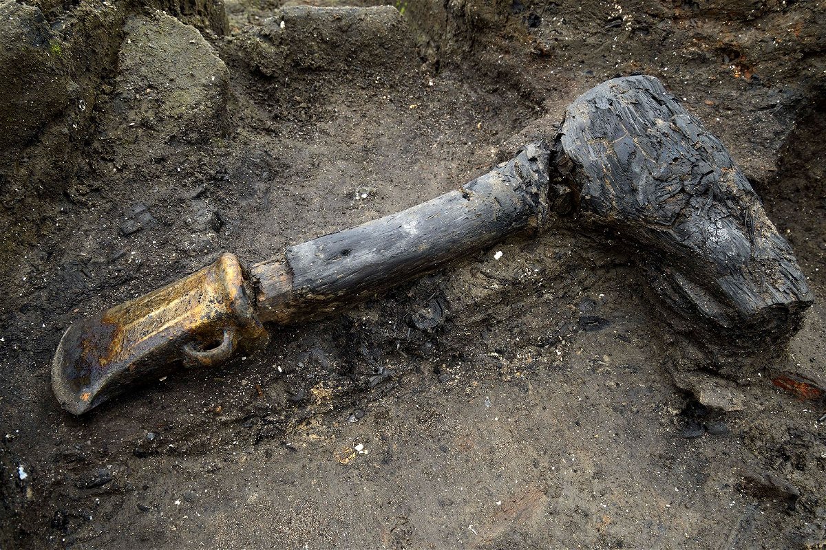 <i>Cambridge Archaeological Unit via CNN Newsource</i><br/>A metal axe head with wooden haft was among the many well preserved artifacts discovered at Must Farm.