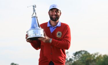 Scheffler poses with the trophy.