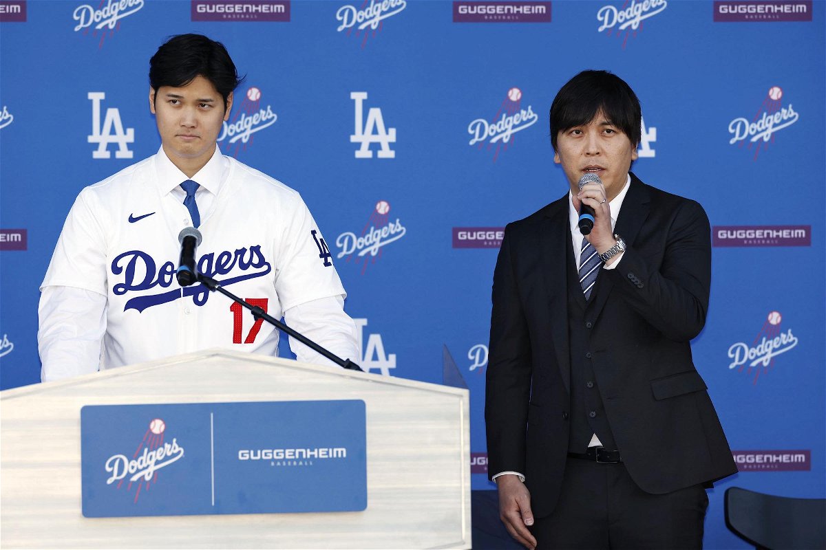 New Los Angeles Dodger Shohei Ohtani (L) attends an introductory press conference with interpreter Ippei Mizuhara on Dec. 14