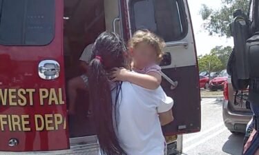 A 3-year-old girl is treated by paramedics outside a Sam's Club in West Palm Beach on May 11.