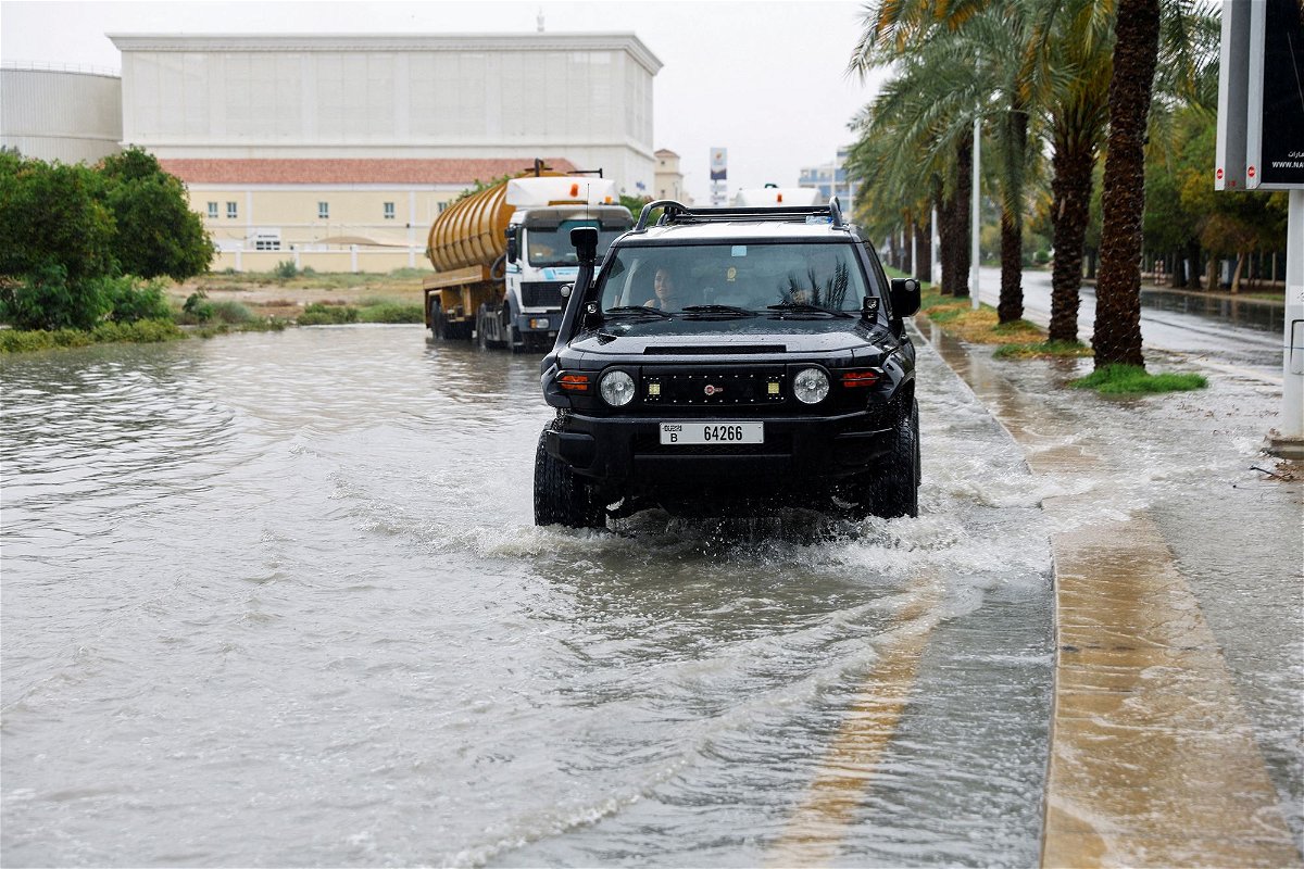 <i>Rula Rouhana/Reuters via CNN Newsource</i><br/>A driver navigates a flooded road following a rainstorm in Dubai on May 2