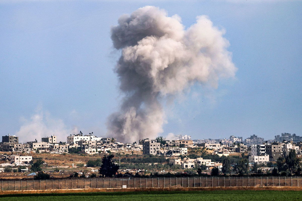 <i>Jack Guez/AFP/Getty Images via CNN Newsource</i><br/>A smoke plume from an explosion in Gaza as seen from a position along Israel's southern border with the Palestinian enclave on May 13.