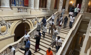 Protesters descend a staircase in the Minnesota State Capitol building in St. Paul