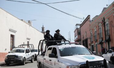 Police officers patrol following the killing of a mayoral candidate who was gunned down in Maravatio