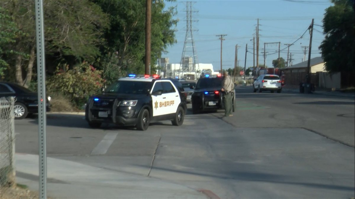 Law enforcement deputies encircle a business in Coachella