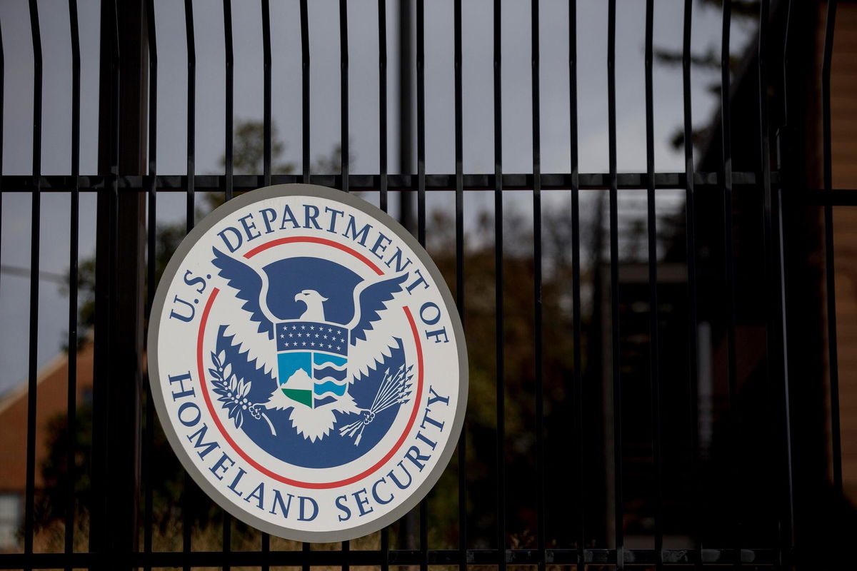 <i>Andrew Harrer/Bloomberg/Getty Images via CNN Newsource</i><br/>The US Department of Homeland Security seal hangs on a fence at the agency's headquarters in Washington