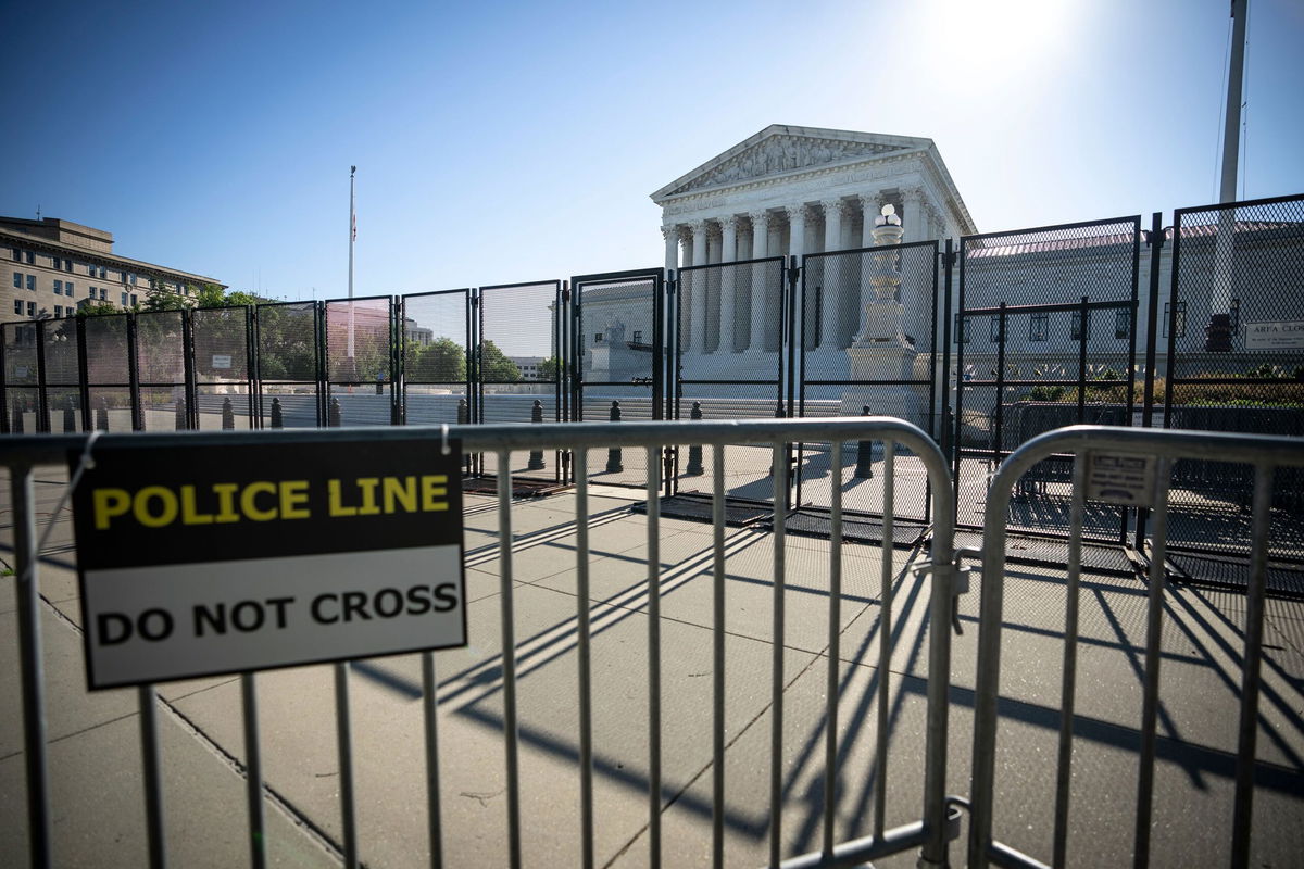 <i>Drew Angerer/Getty Images via CNN Newsource</i><br/>Security fencing surrounds the U.S. Supreme Court in June 2022 in Washington