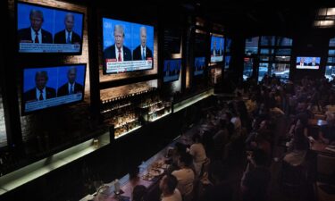 Guests at the Old Town Pour House watch the debate between President Joe Biden and presumptive Republican nominee former President Donald Trump on June 27