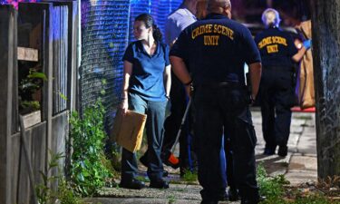 Police crime tape is seen around the area where children's bicycles and baby strollers stand near the scene of the Fourth of July parade shooting that killed seven people in Highland Park