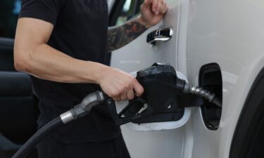 A customer gets gas at a Shell station on May 15 in Miami