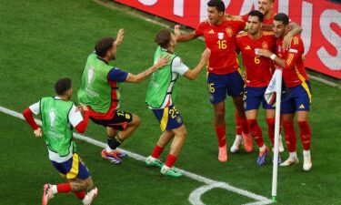 Spain's Mikel Merino celebrates with teammates after scoring the quarterfinal winner against Germany.