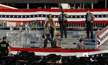 Law enforcement agents pictured near the stage of a campaign rally for Republican presidential candidate former President Donald Trump on July 13