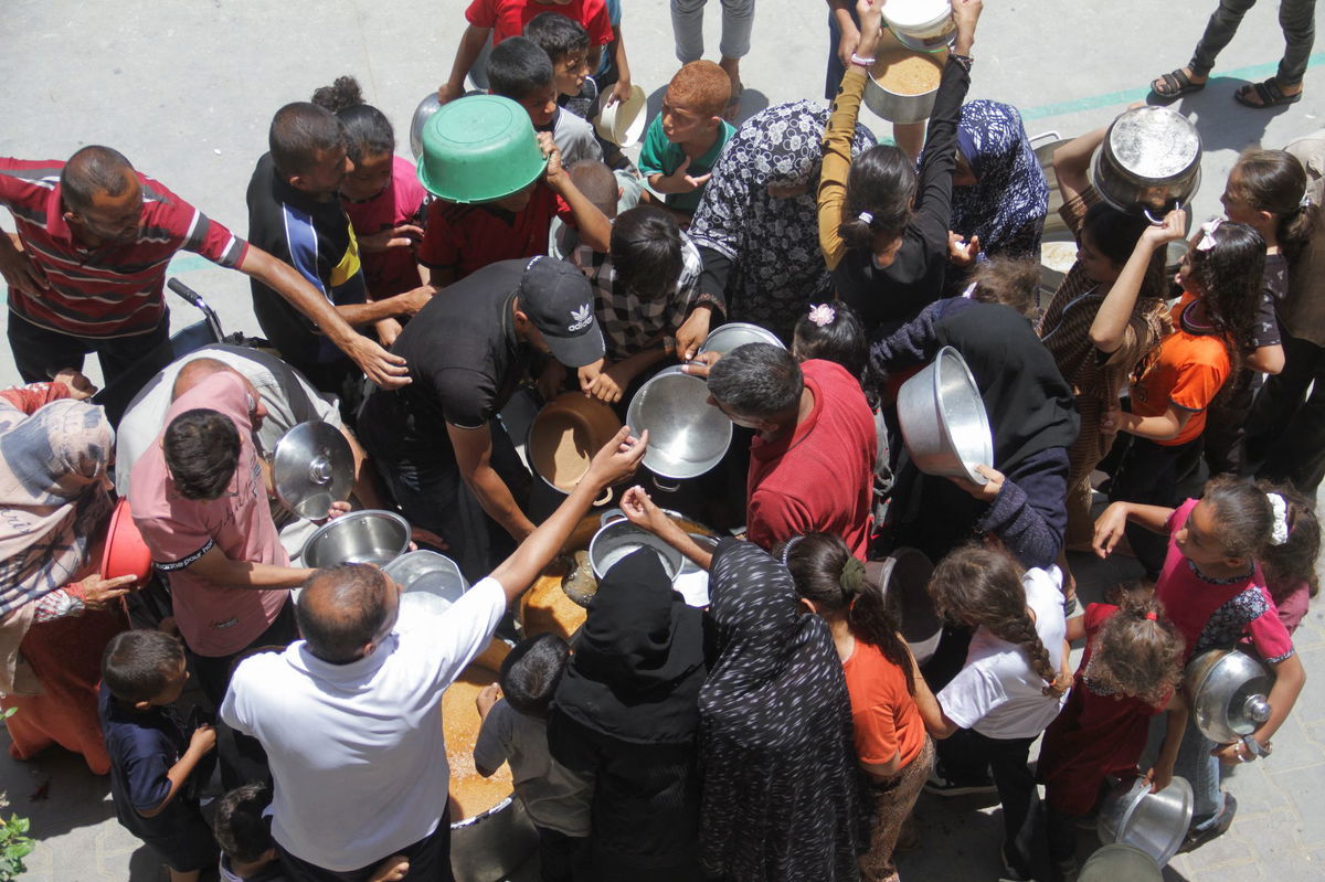 <i>Mahmoud Issa/Reuters via CNN Newsource</i><br/>Palestinians gather to receive food cooked by a charity kitchen in Jabalia refugee camp