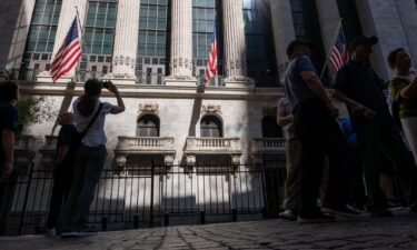 People walk through the Financial District near the New York Stock Exchange on July 11