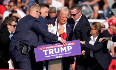 Republican presidential candidate former President Donald Trump is helped off the stage at a campaign event in Butler
