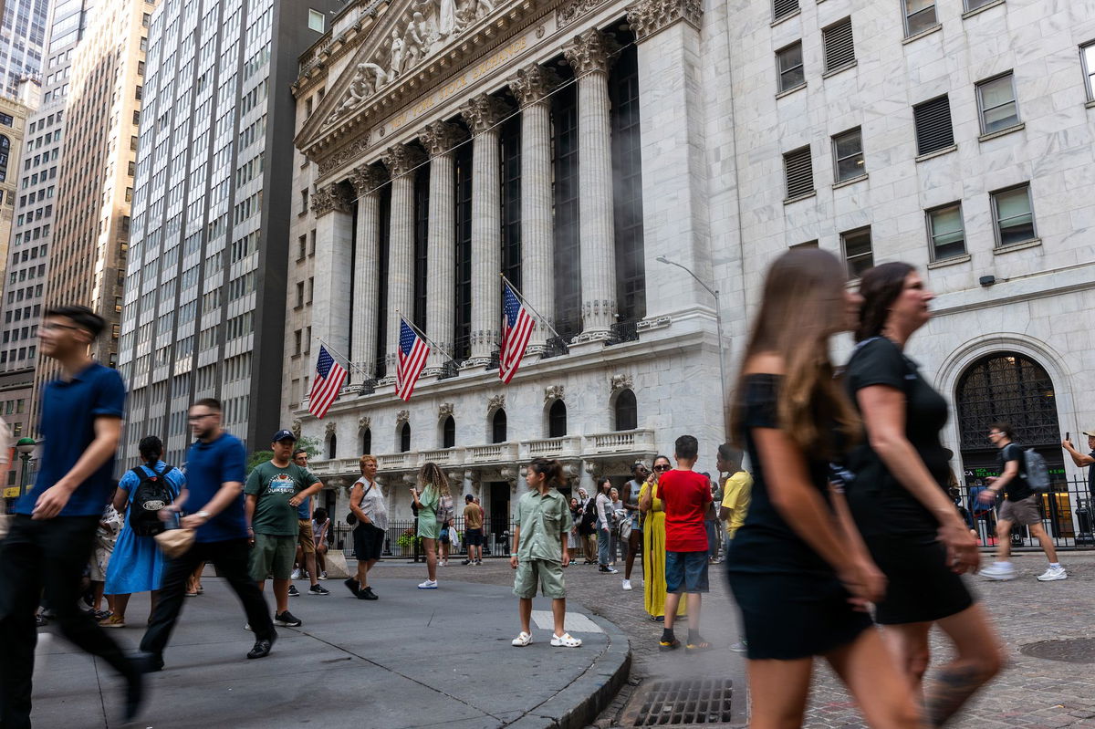 <i>Spencer Platt/Getty Images via CNN Newsource</i><br/>People walk through the financial district by the New York Stock Exchange (NYSE) on August 14