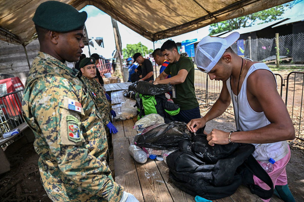 <i>Martin Bernetti/AFP/Getty Images/File via CNN Newsource</i><br/>People arrive at the Reception Center for Migrant Care in Lajas Blancas